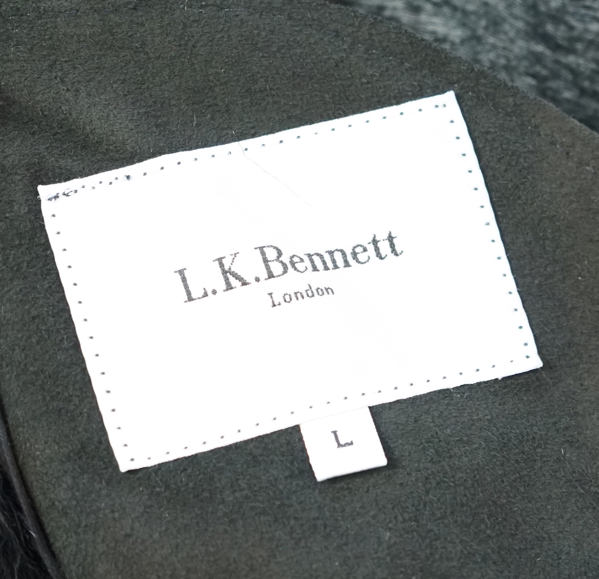 A lady's L K Bennett black shearling jacket, size Large